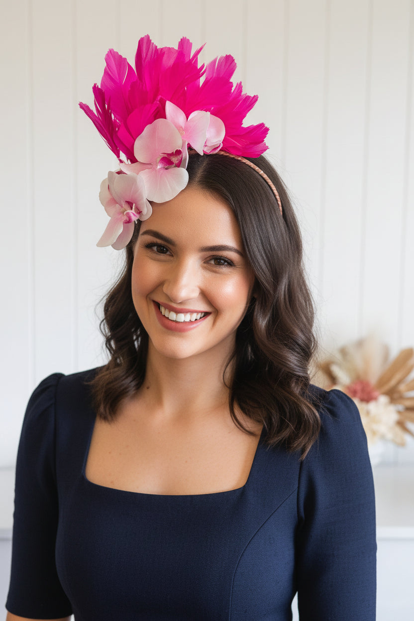 Mannequin head with pink and white flowers on a white surface with a white background